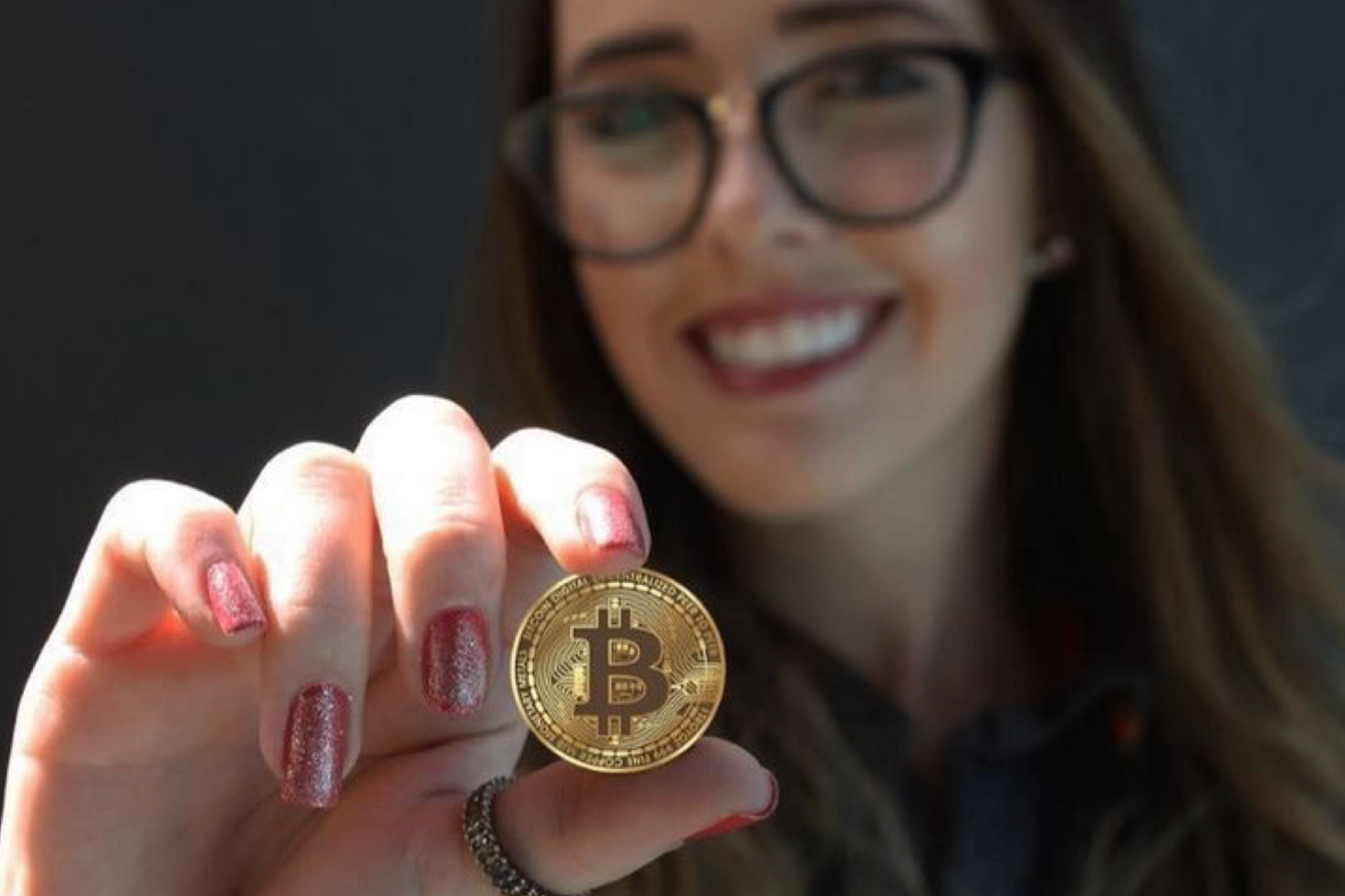 Trader holding a Bitcoin coin